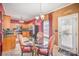 Breakfast nook featuring red-patterned chairs and a view into the kitchen at 8134 Chatham Oaks Dr, Concord, NC 28027