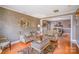 Open concept dining room with hardwood flooring, elegant chandelier, and views of the living room at 8134 Chatham Oaks Dr, Concord, NC 28027