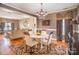 Open concept dining room with hardwood flooring, elegant chandelier, and views of the living room at 8134 Chatham Oaks Dr, Concord, NC 28027