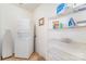 Practical laundry area with washer, dryer, storage shelves, and tile flooring at 8134 Chatham Oaks Dr, Concord, NC 28027