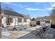 Beautiful backyard featuring a pool, lounge chairs, and a charming shed with unique architectural details at 8408 Williamsburg Cir, Huntersville, NC 28078