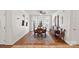 Bright dining room with hardwood floors, large windows, and a classic wooden table at 8408 Williamsburg Cir, Huntersville, NC 28078