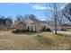 Charming single-story home features a brick facade, well-maintained lawn, and attached two-car garage at 8408 Williamsburg Cir, Huntersville, NC 28078