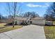 Attractive home with a well-manicured lawn, a long driveway, and an attached two-car garage at 8408 Williamsburg Cir, Huntersville, NC 28078