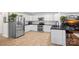 Modern kitchen with stainless steel appliances, white cabinets, and tiled backsplash at 8408 Williamsburg Cir, Huntersville, NC 28078