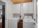 Well-organized laundry room with overhead cabinets and modern appliances, maximizing efficiency and space at 8408 Williamsburg Cir, Huntersville, NC 28078