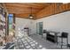 Covered patio featuring a grill, seating area, and ceiling fans, ideal for outdoor entertaining and relaxation at 8408 Williamsburg Cir, Huntersville, NC 28078