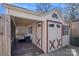 View of a charming shed featuring double doors with red accents and a screened-in porch area at 8408 Williamsburg Cir, Huntersville, NC 28078