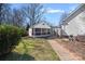 Backyard view of a shed with a screened porch and a brick pathway at 8408 Williamsburg Cir, Huntersville, NC 28078