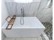 Freestanding tub with marble tile surround and shower at 881 Saluda Rd, Chester, SC 29706