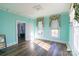 Bright bedroom features classic trim, two windows, and wood-look flooring at 881 Saluda Rd, Chester, SC 29706