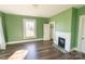 Bright bedroom featuring wood floors, a fireplace, and a window letting in lots of natural light at 881 Saluda Rd, Chester, SC 29706