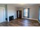 Cozy bedroom with hardwood floors, fireplace, and large window, offering a warm and inviting space at 881 Saluda Rd, Chester, SC 29706
