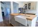Kitchen island boasts a butcher block countertop and farmhouse sink, and offers views to the living room at 881 Saluda Rd, Chester, SC 29706