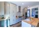 This kitchen boasts a modern vent hood, stainless appliances, hardwood floors and island sink at 881 Saluda Rd, Chester, SC 29706