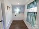 Cozy laundry room with wood-look flooring, built in storage and bright natural light at 881 Saluda Rd, Chester, SC 29706