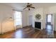 This living room features a fireplace, ample natural light, hardwood floors, and a ceiling fan at 881 Saluda Rd, Chester, SC 29706