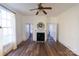 Living room boasts hardwood floors, a fireplace, a ceiling fan and great light from many windows at 881 Saluda Rd, Chester, SC 29706