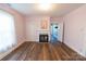 Living room with fireplace, wood-look flooring and pink walls at 881 Saluda Rd, Chester, SC 29706