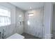 White tile shower with mosaic floor and built-in storage at 881 Saluda Rd, Chester, SC 29706
