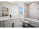 Modern bathroom featuring sleek white vanity, black hardware, tile flooring, and a separate tub and shower at 904 Van Every St, Charlotte, NC 28205