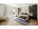Main bedroom featuring modern decor, large windows, and a luxurious king-sized bed with plush bedding at 904 Van Every St, Charlotte, NC 28205
