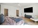 Large bedroom with lots of natural light, modern decor, a ceiling fan, and a seating area with a chair at 904 Van Every St, Charlotte, NC 28205