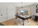 Bright game room featuring a modern pool table with overhead lighting and a view from a large window at 904 Van Every St, Charlotte, NC 28205