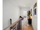 Bright hallway featuring hardwood floors, modern art, and a view of the main living area and staircase at 904 Van Every St, Charlotte, NC 28205