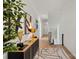 Bright hallway featuring light wood floors, contemporary decor, and a staircase leading to the upper level at 904 Van Every St, Charlotte, NC 28205