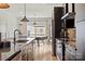 Modern kitchen featuring stainless steel appliances, an island with a sink, and lots of space for entertaining at 904 Van Every St, Charlotte, NC 28205