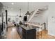 Open-concept kitchen with modern island, stainless steel appliances, seamless flow into living area, and natural light at 904 Van Every St, Charlotte, NC 28205