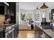 Bright living room with open layout, modern finishes, sleek kitchen island, and ample natural light at 904 Van Every St, Charlotte, NC 28205