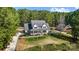 Stunning aerial view of a home with well-manicured lawns, mature landscaping, and a classic white picket fence at 932 Dovefield Dr, York, SC 29745