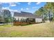 Expansive backyard featuring a screened porch, brick foundation, and a classic white picket fence at 932 Dovefield Dr, York, SC 29745