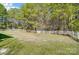 Lush backyard featuring manicured lawn, mature trees, and a classic white picket fence at 932 Dovefield Dr, York, SC 29745