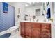 Bathroom featuring a wood vanity, ample storage, a coordinating shower curtain, and bright lighting at 932 Dovefield Dr, York, SC 29745