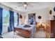 Cozy bedroom with a wooden bed frame, soft blue linens, and natural light from the bright window at 932 Dovefield Dr, York, SC 29745