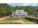 Stunning two-story home boasts a welcoming front porch and well-manicured lawn surrounded by mature trees at 932 Dovefield Dr, York, SC 29745