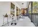 Inviting front porch with wicker furniture, decorative pillows, and multiple windows overlooking the outdoors at 932 Dovefield Dr, York, SC 29745