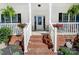 Inviting front porch with brick steps and decorative planters creates a warm welcome at 932 Dovefield Dr, York, SC 29745