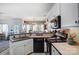 Kitchen with black appliances and a view into the dining area at 932 Dovefield Dr, York, SC 29745