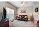 Cozy living room featuring plush carpet, a leather sofa, and natural light from a bright window at 932 Dovefield Dr, York, SC 29745