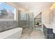 Stylish bathroom featuring a glass shower, soaking tub, and double sink vanity at 106 Orange St, Charlotte, NC 28205
