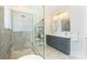 Well-lit bathroom boasting a glass shower, double sinks, and marble floors at 106 Orange St, Charlotte, NC 28205