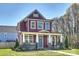 Charming two-story home with a welcoming front porch and beautiful landscaping at 106 Orange St, Charlotte, NC 28205