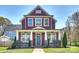 Charming two-story home with a welcoming front porch and beautiful landscaping at 106 Orange St, Charlotte, NC 28205