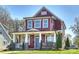 Charming two-story home with a welcoming front porch and beautiful landscaping at 106 Orange St, Charlotte, NC 28205