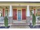 Inviting front porch with detailed columns, ceiling fans, and fresh landscaping at 106 Orange St, Charlotte, NC 28205