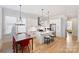 Bright, open kitchen features white cabinets, island, and stainless-steel appliances at 106 Orange St, Charlotte, NC 28205